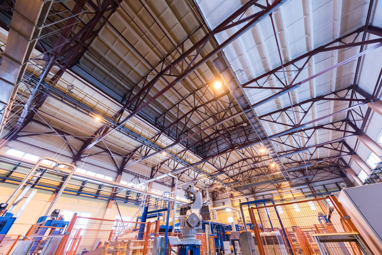 Business owner inspecting a modern industrial warehouse in Norwalk with high ceilings, heavy power infrastructure, and loading docks.